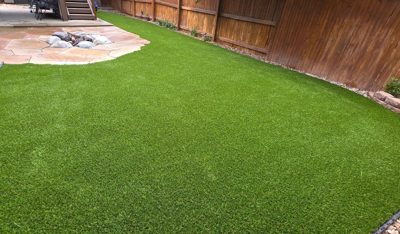 Backyard Artificial Turf Install Next to a Flagstone Patio image