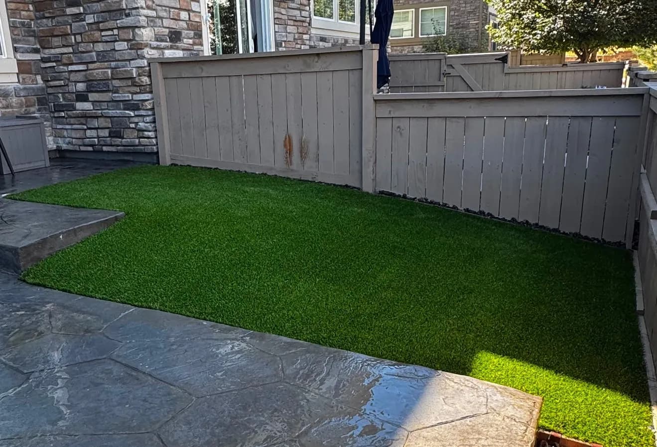 Gallery photos for Artificial Turf Turns a Rocky Patio Corner Into a Pet-Friendly Spot: Image #1
