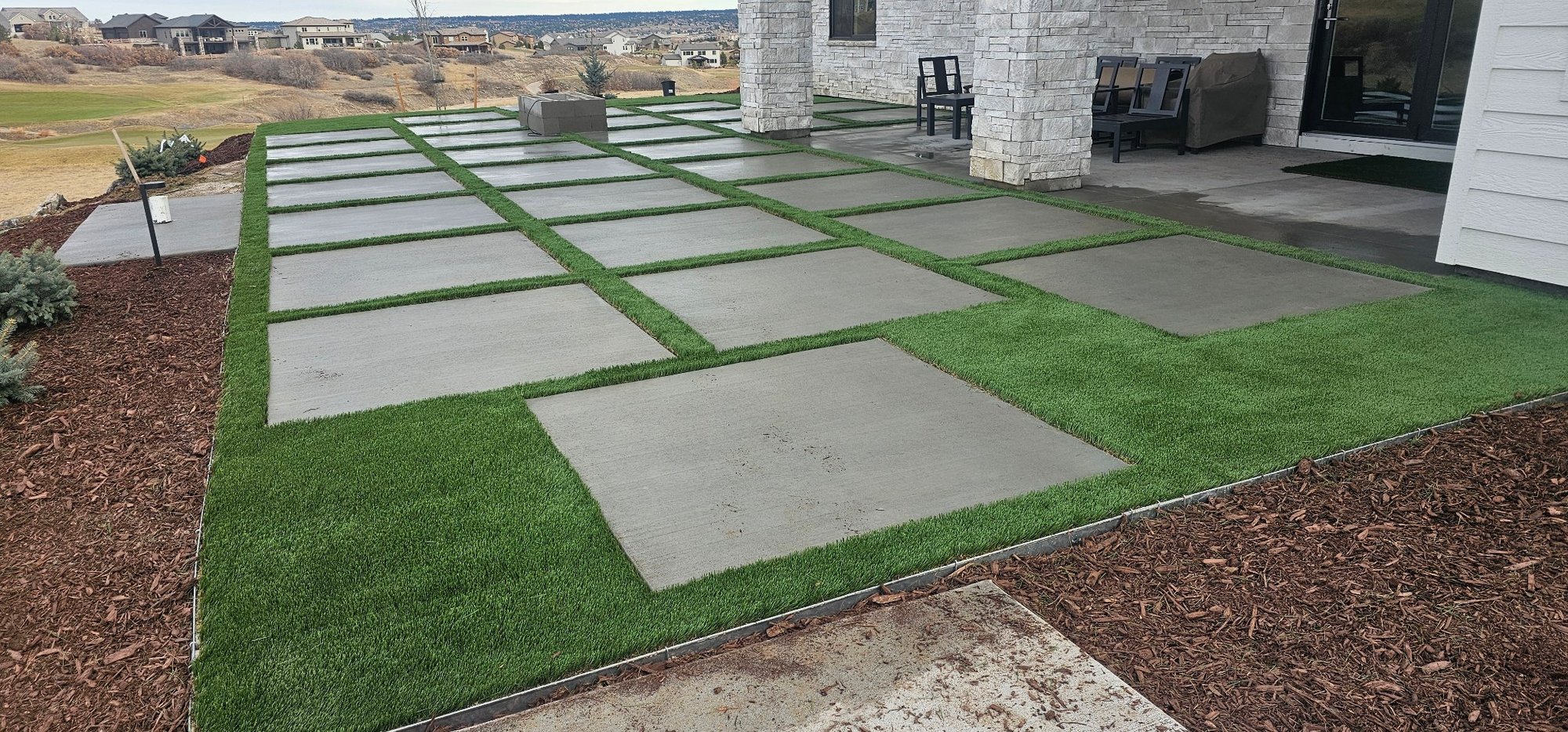 Backyard patio area with turf between joints