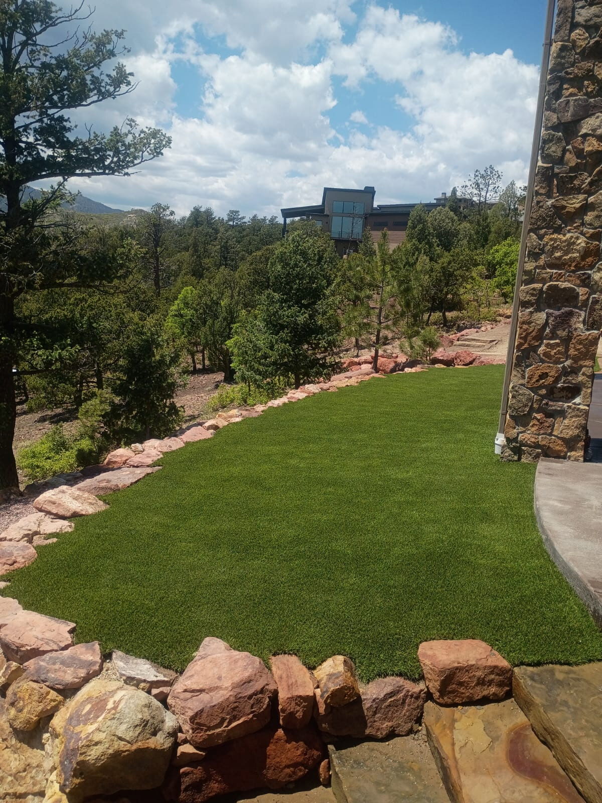 Artificial turf fit to natural stone wall