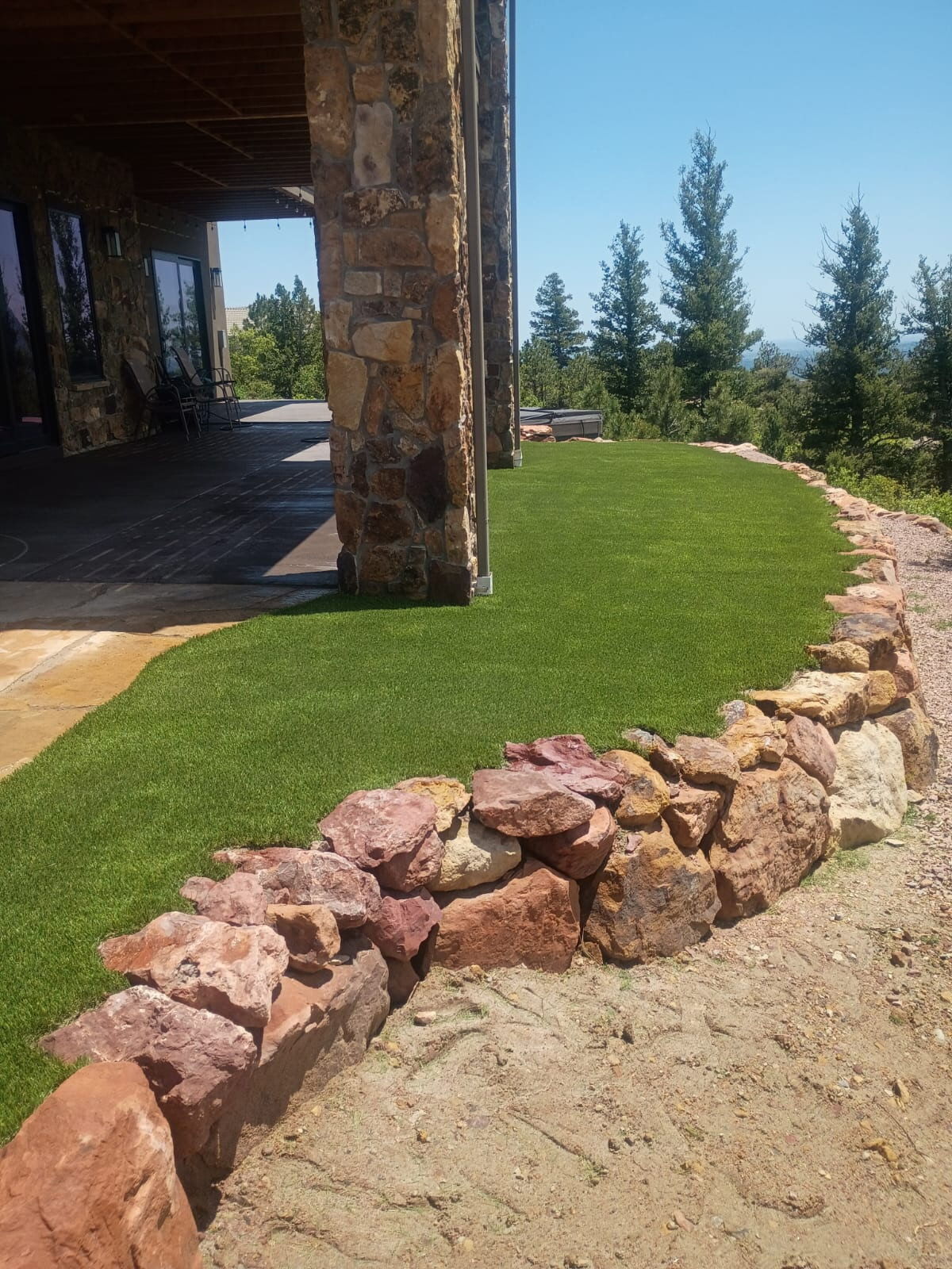 Artificial turf fit to natural stone wall